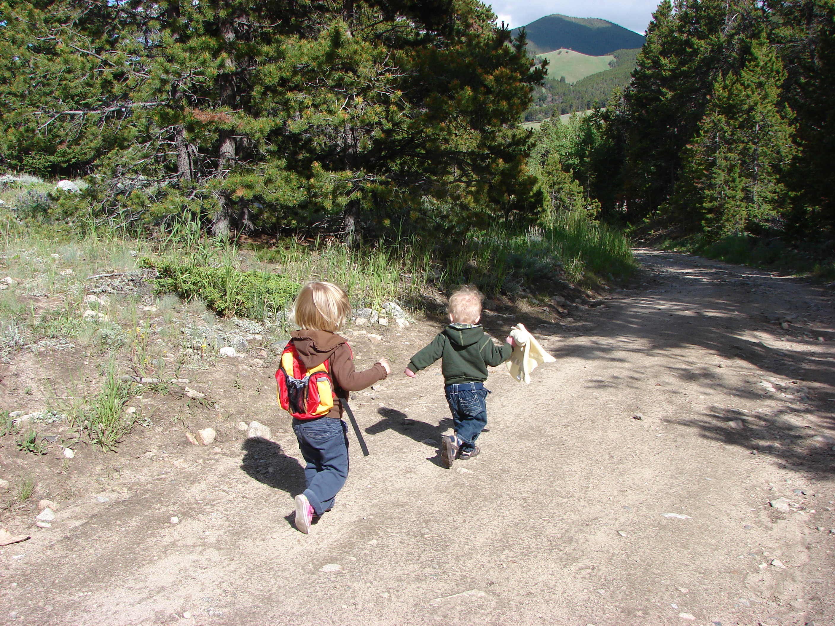 June and Matteo run down the trail.