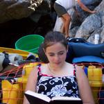 Sara chose to stay in the boat and read.