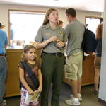 The next day, Conli became a Junior Ranger.  The ranger asks for everyone's attention.