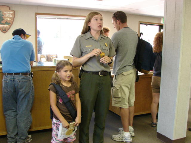 The next day, Conli became a Junior Ranger.  The ranger asks for everyone's attention.