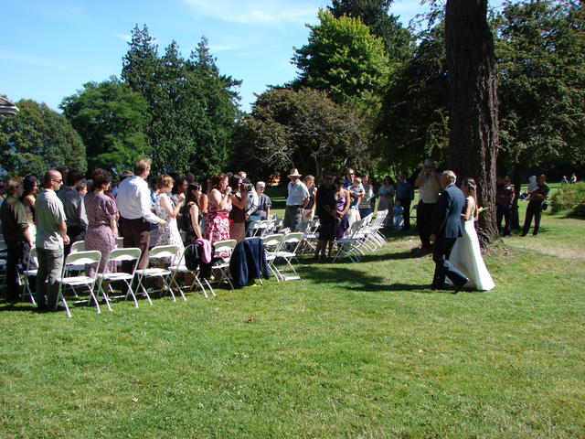 Everyone is snapping pictures as Lindsay enters with her dad.