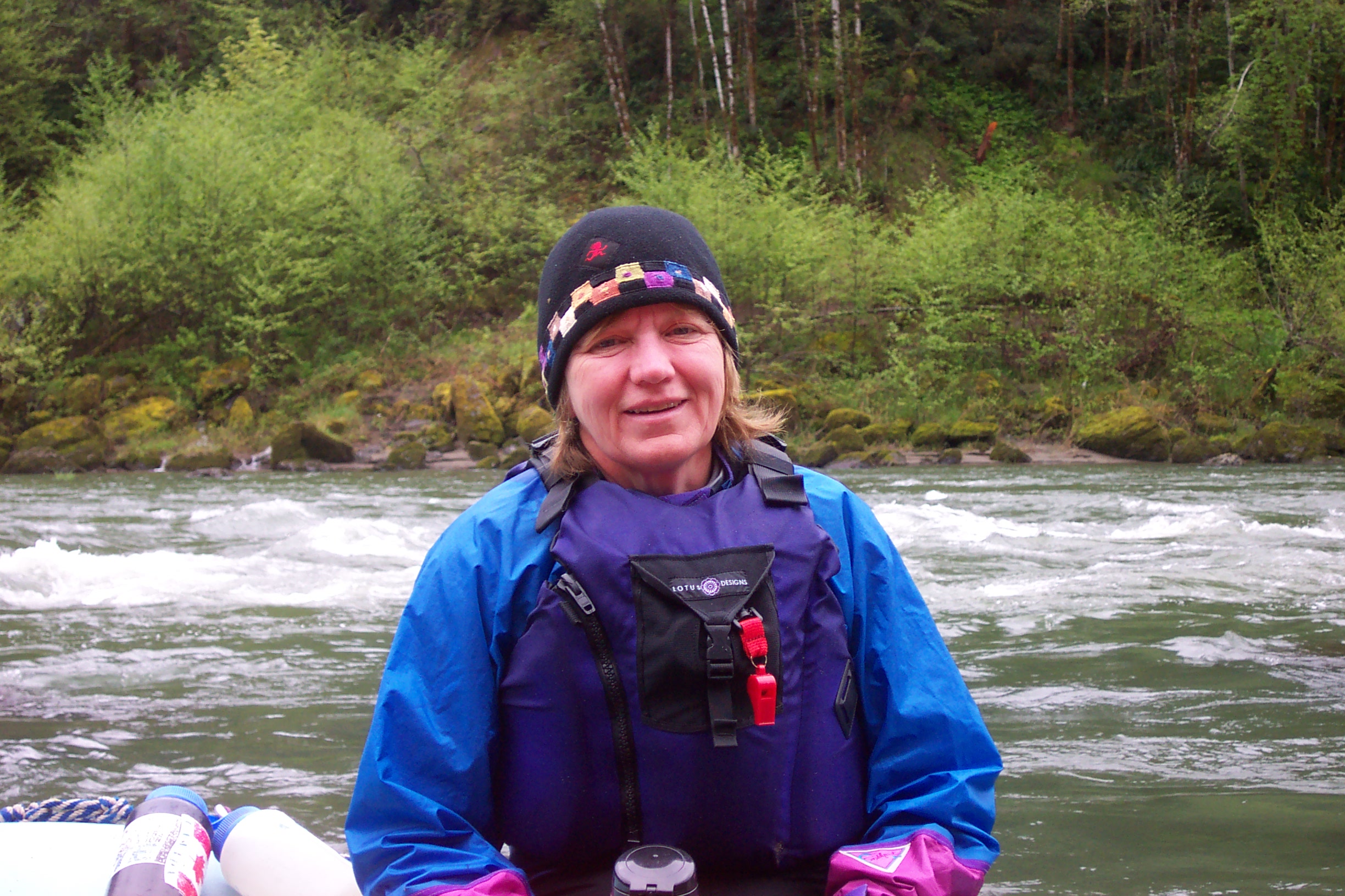 Chris climbs out of her boat to relax on the raft.