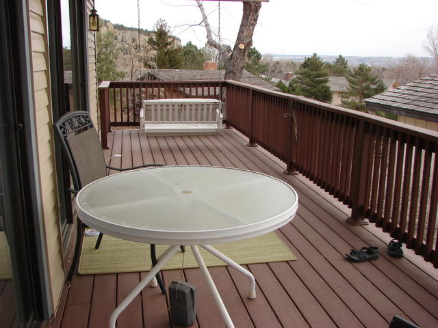 Deck with swing that was a birthday present from JJ and kids.  Two chairs bought at Billings Hardware.