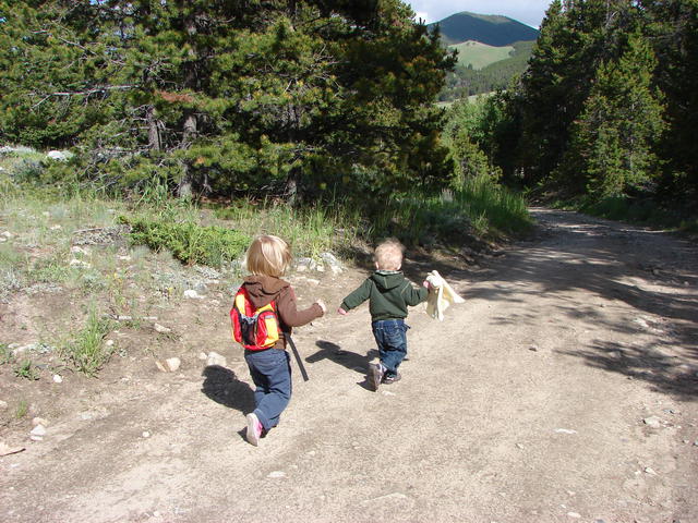 June and Matteo run down the trail.