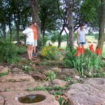 The neighbors, Lori and Robby, stop by to admire the garden.