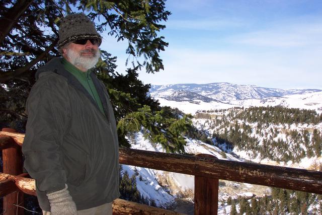 Behind Mike are hot springs and the Yellowstone River.