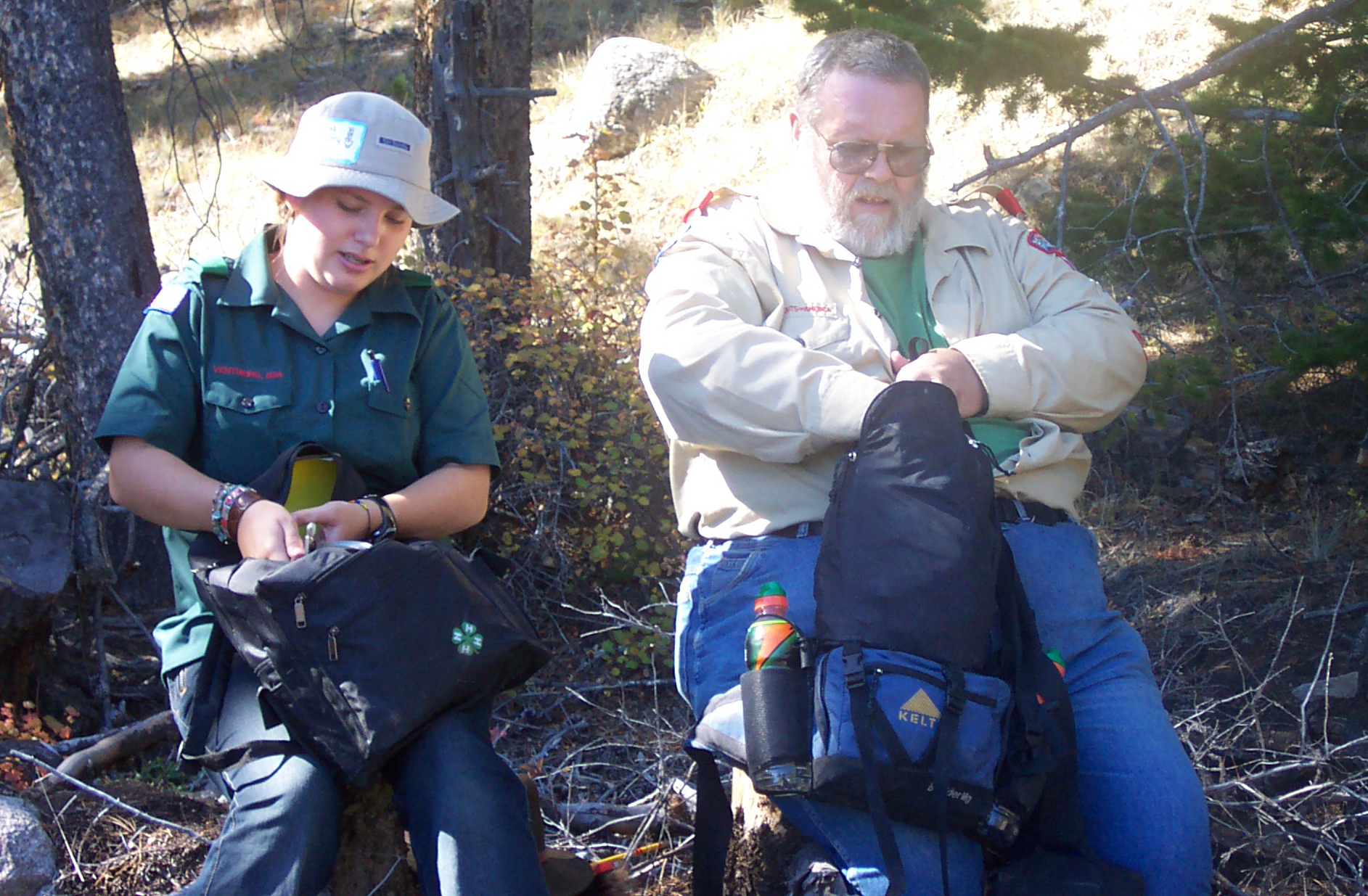 Earl and Melissa are checking the backpacks for lunch.